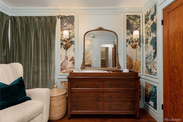 a living room with furniture and a mirror