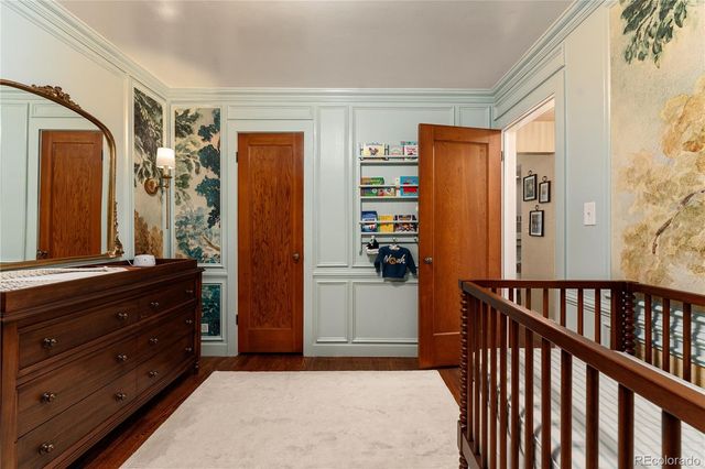 a view of a hallway with closet and wooden floor
