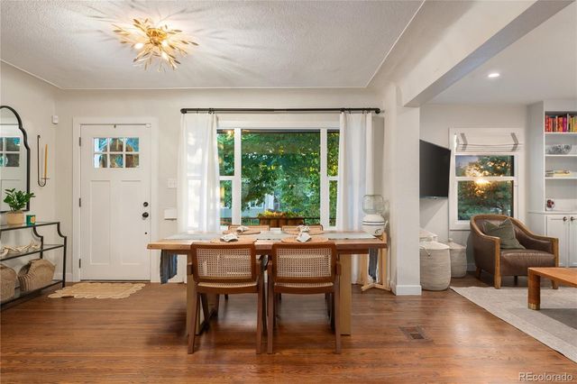 a view of a dining room with furniture window and wooden floor