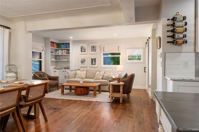 a living room with furniture wooden floor and a table