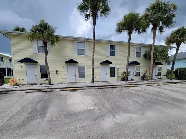 front view of house with palm trees