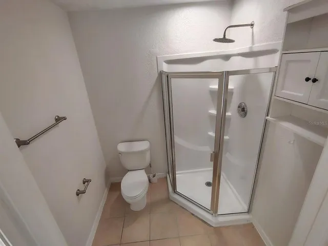 a view of a livingroom with a ceiling fan and window