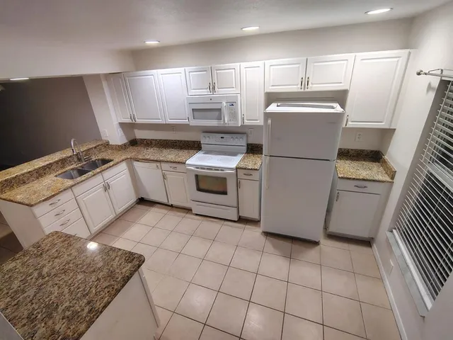 a kitchen with a stove a refrigerator and a sink