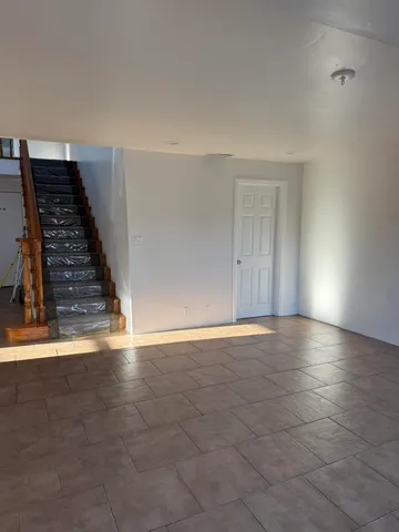 a kitchen with stainless steel appliances granite countertop a stove a sink a refrigerator a counter space and cabinets