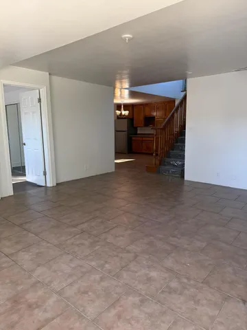 a view of a small space with wooden floor and a window