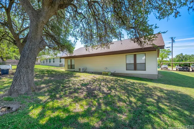 a front view of a house with a garden and yard