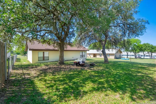 a view of a porch with a table and chair and potted plants