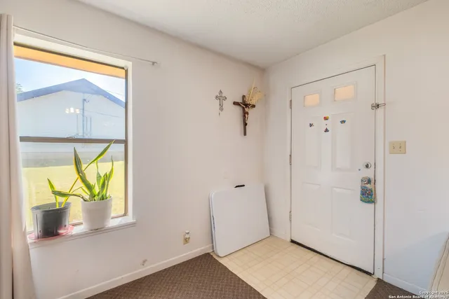 a kitchen with a refrigerator a stove a washer and dryer
