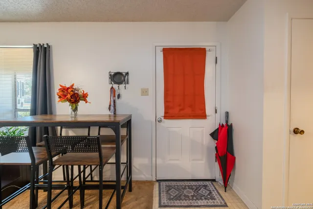 a living room with furniture a window and a flat screen tv