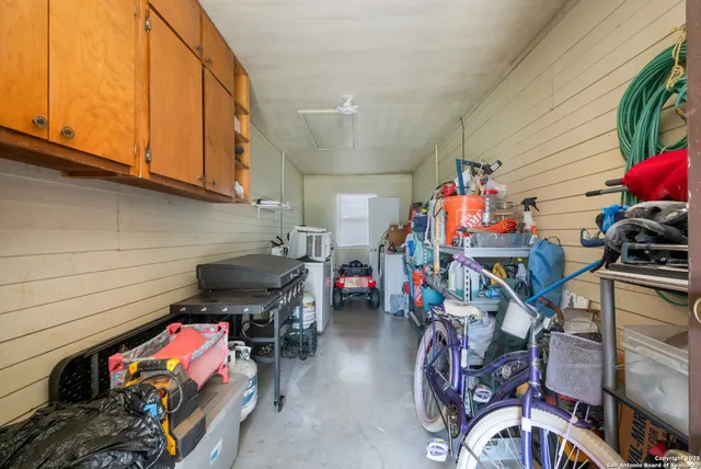an aerial view of residential houses with outdoor space and street view