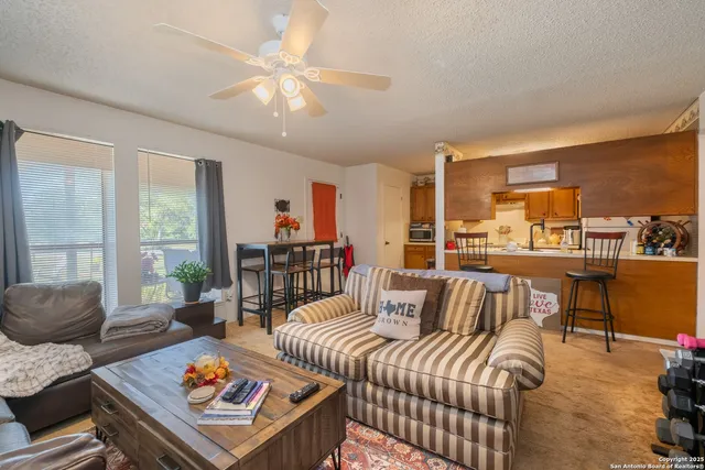 a kitchen with stainless steel appliances granite countertop a refrigerator a stove and a sink