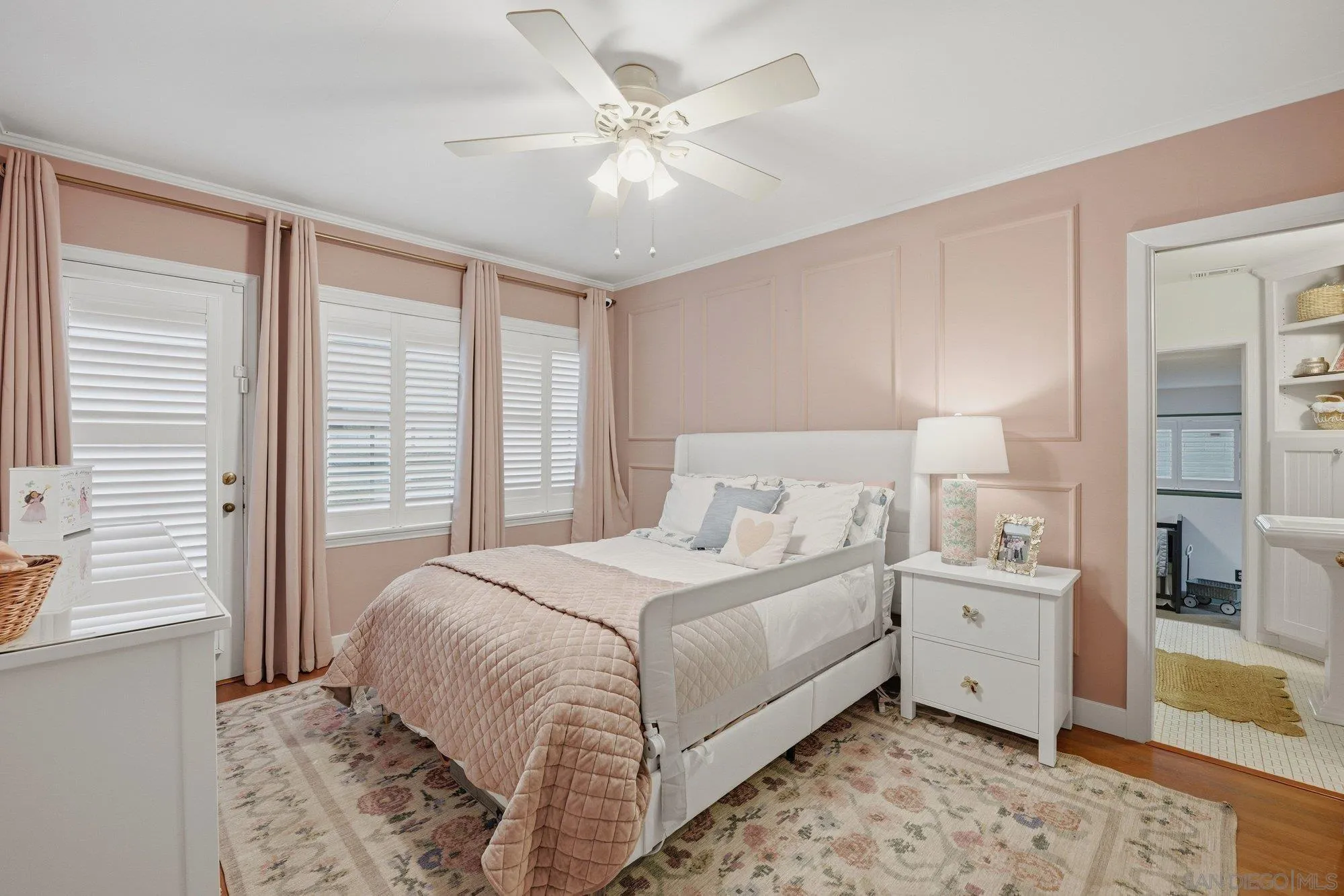 1210 Third Street Coronado, CA 92118 - Photo 12 of 22 a bedroom with a large bed and a chandelier