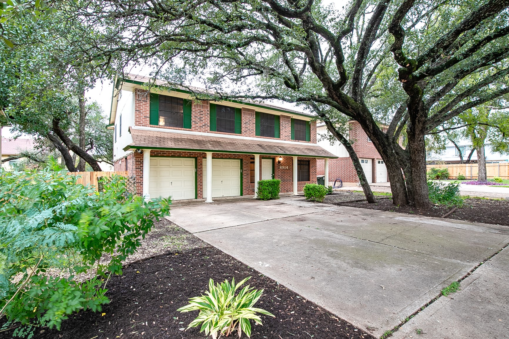 6914 Dallas Drive Austin, TX 78729 - Photo 2 of 31 a front view of a house with a yard and trees