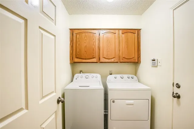 a view of a house with backyard and a tree