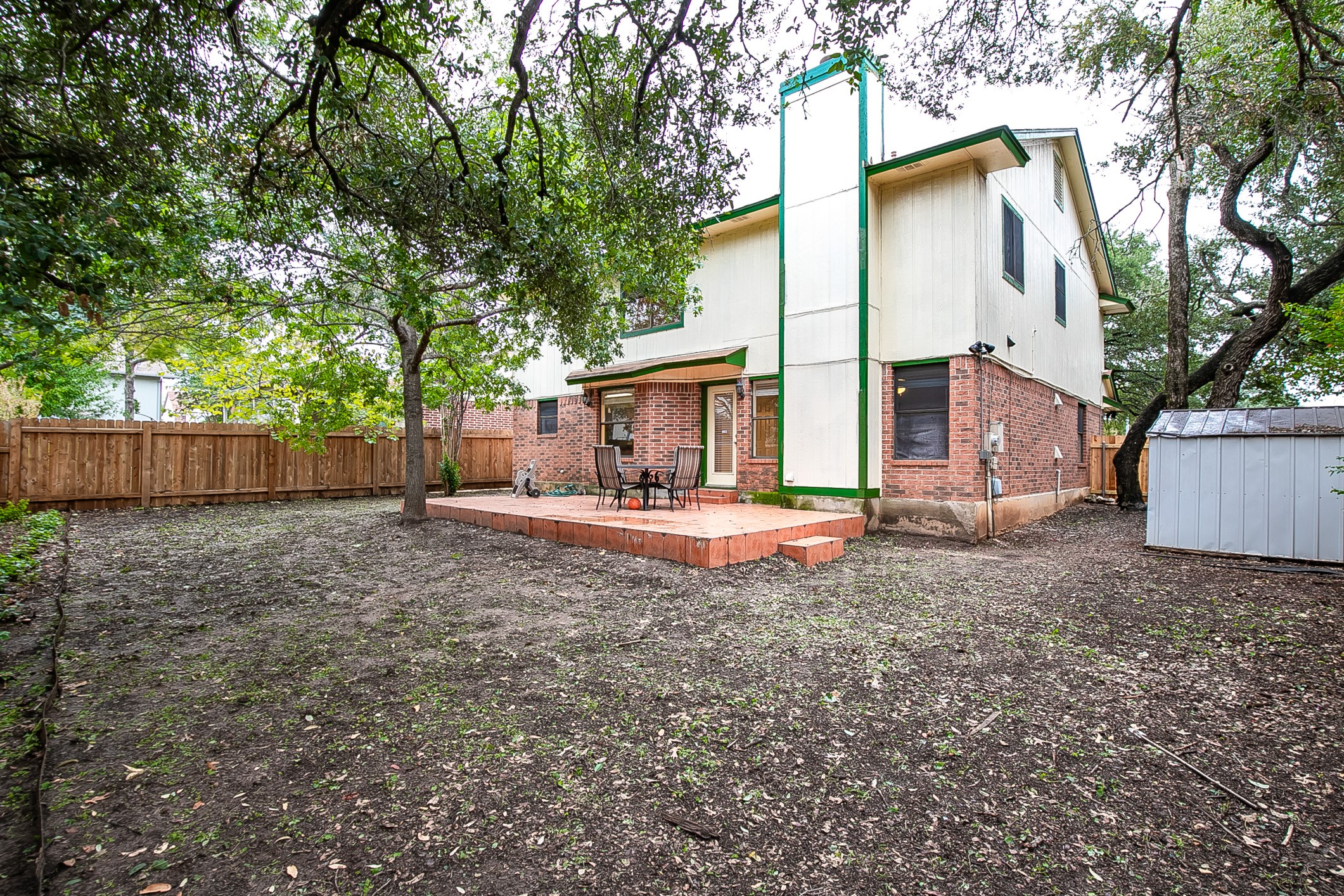 6914 Dallas Drive Austin, TX 78729 - Photo 30 of 31 a view of a house with backyard and a tree