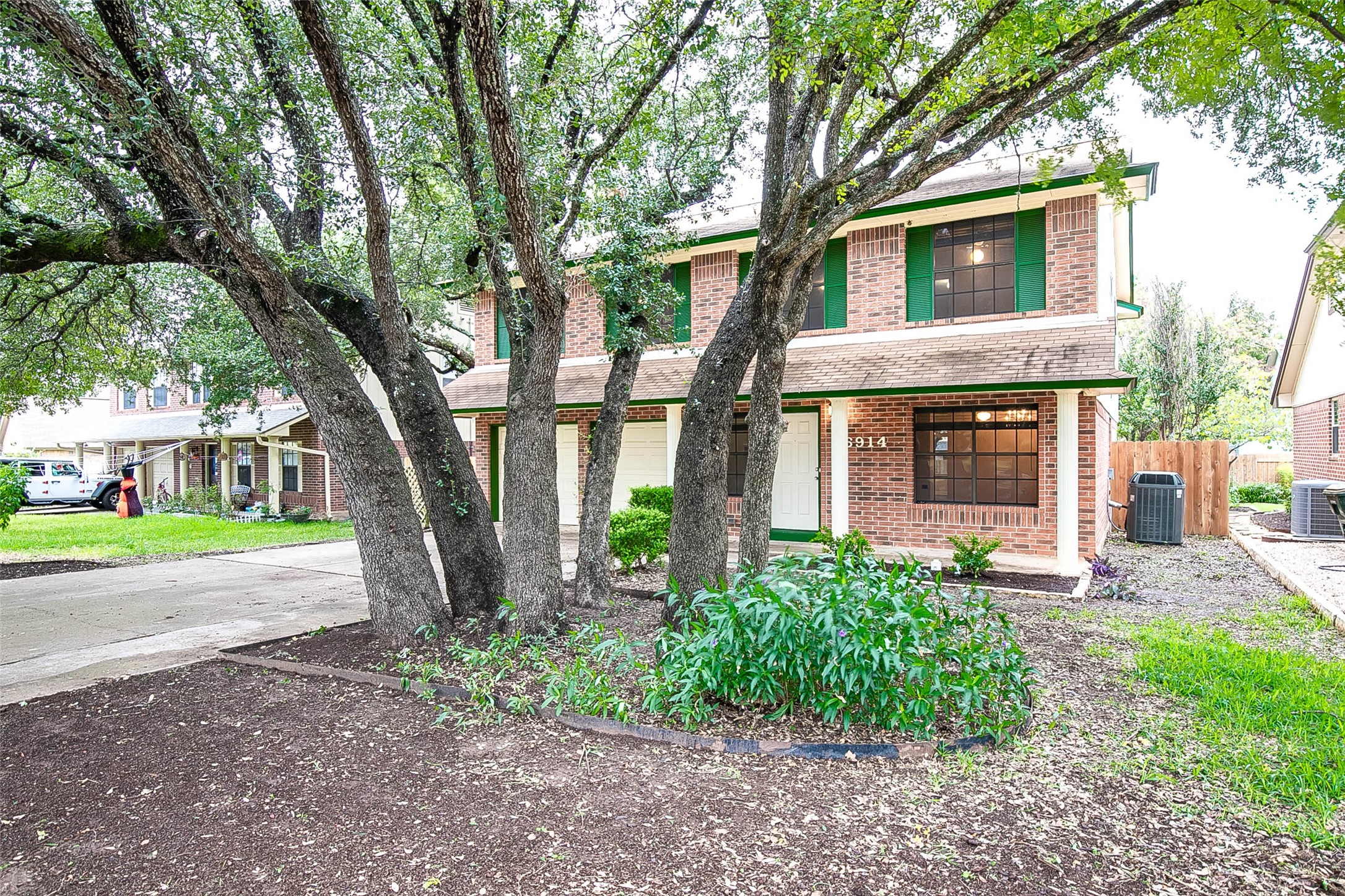 6914 Dallas Drive Austin, TX 78729 - Photo 3 of 31 a front view of a house with garden and trees