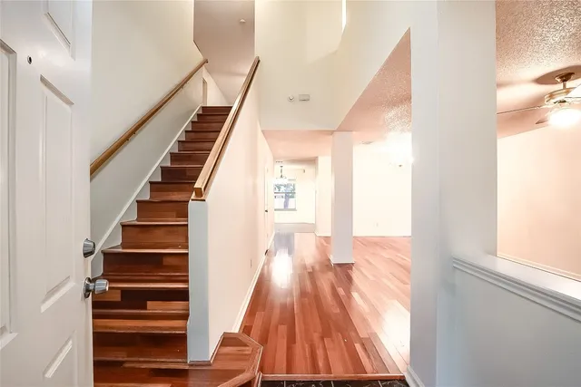 a view of entryway and hall with wooden floor