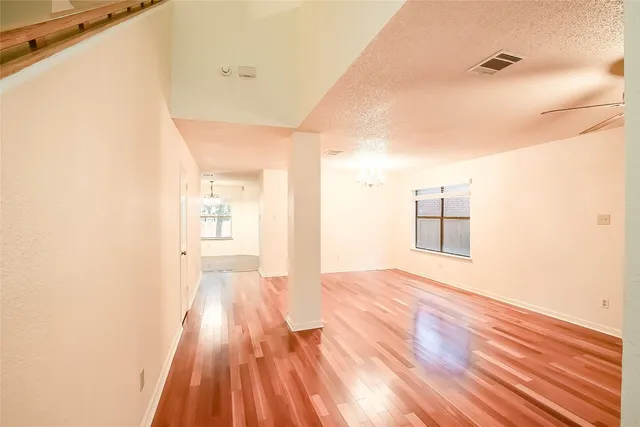a view of a room with wooden floor and a bathroom