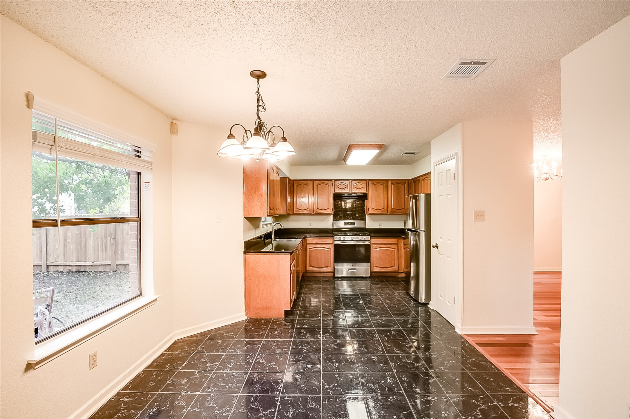 6914 Dallas Drive Austin, TX 78729 - Photo 10 of 31 a view of a kitchen and dining room