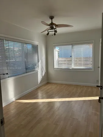 a view of a livingroom with a ceiling fan and window