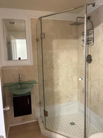 a bathroom with a shower and a sink
