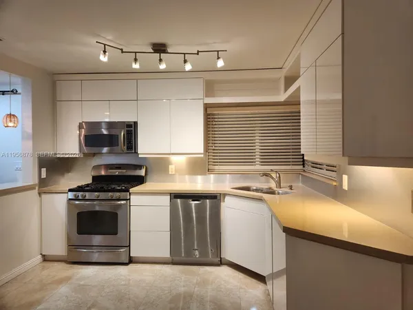 a kitchen with a sink stove and microwave