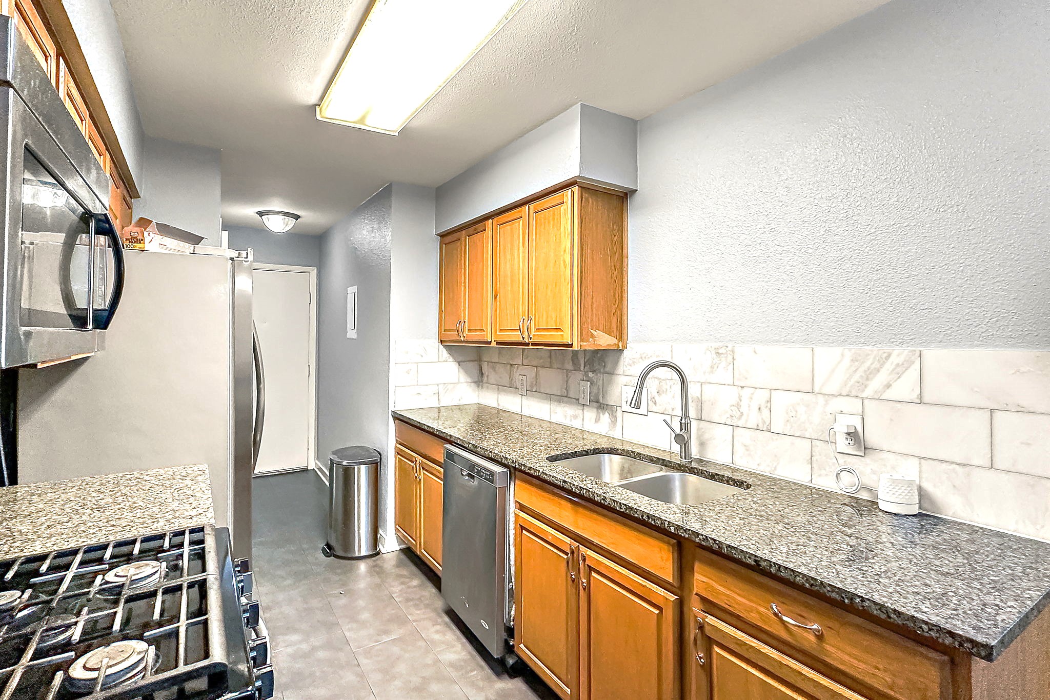 700 Misty Morning Way Round Rock, TX 78664 - Photo 9 of 36 Unit B - A well-appointed kitchen features ample cabinetry, granite counters, and stainless steel appliances.