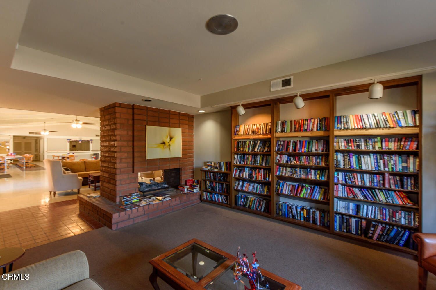 11405 Darling Road, Unit 1 Ventura, CA 93004 - Photo 28 of 31 a living room with furniture a rug and a book shelf