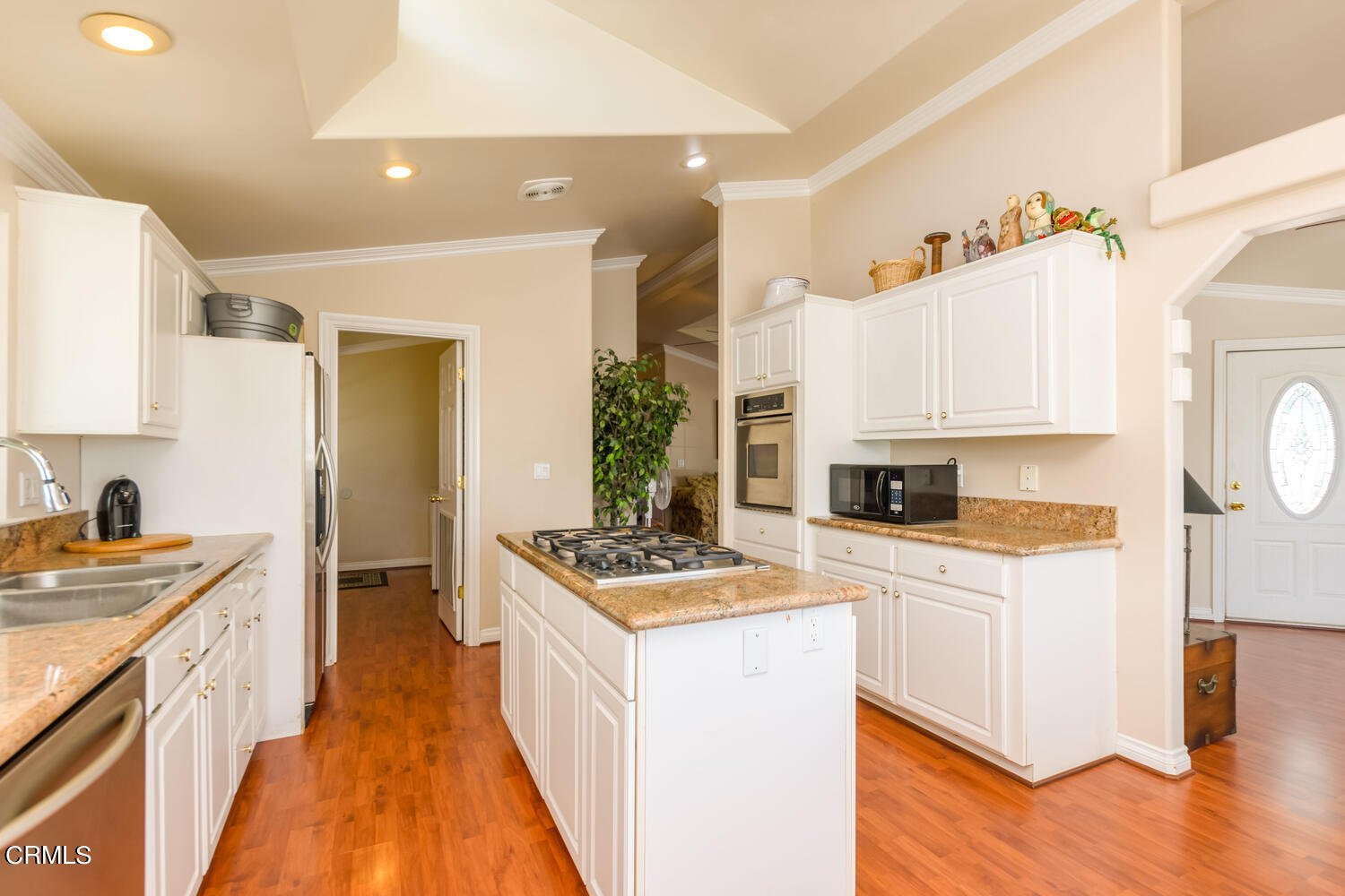 11405 Darling Road, Unit 1 Ventura, CA 93004 - Photo 8 of 31 a kitchen with stainless steel appliances kitchen island wooden cabinets a stove a sink a chimney and a refrigerator
