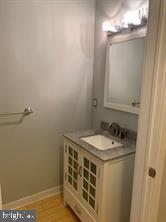 4742 Pine Street, Unit 104 Philadelphia, PA 19143 - Photo 12 of 12 a bathroom with a sink and a mirror