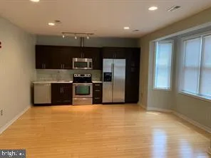 a kitchen with stainless steel appliances a refrigerator and a microwave