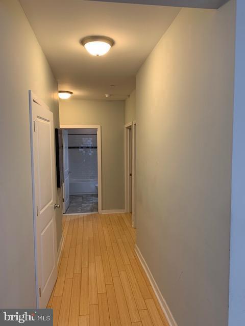 4742 Pine Street, Unit 104 Philadelphia, PA 19143 - Photo 7 of 12 a view of hallway with wooden floor