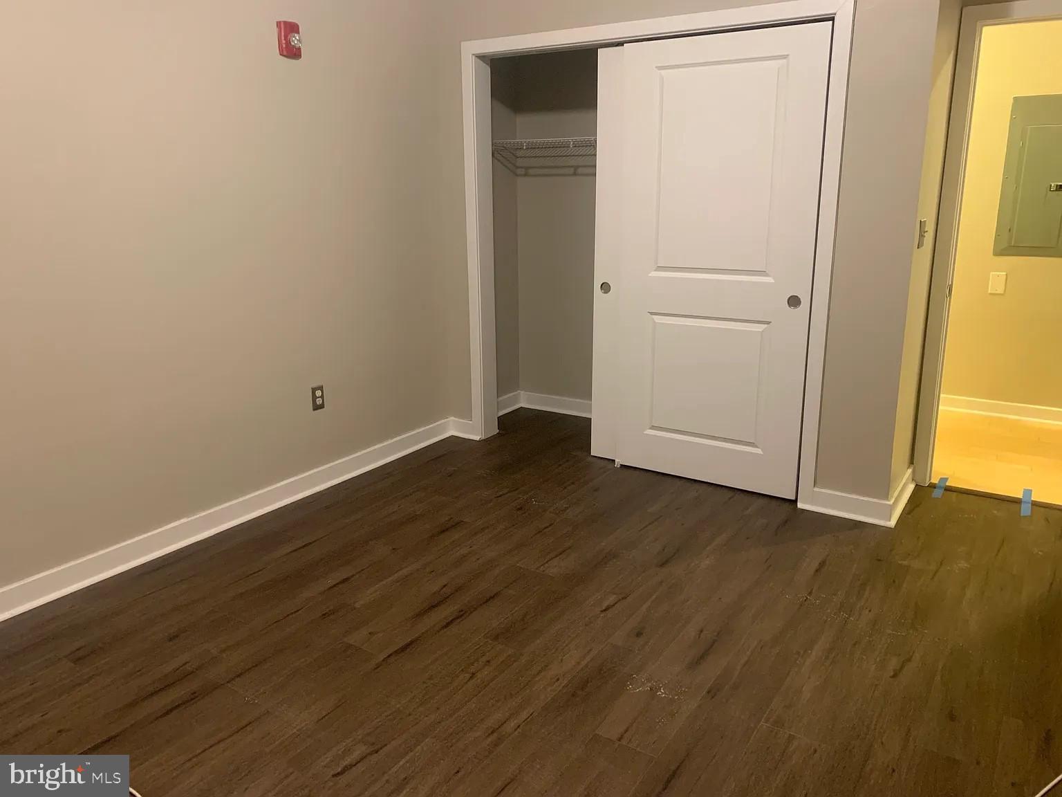 4742 Pine Street, Unit 104 Philadelphia, PA 19143 - Photo 8 of 12 an empty room with wooden floor