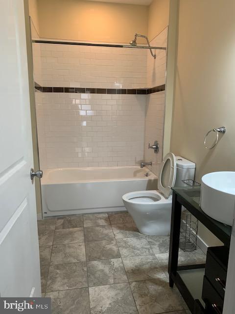 4742 Pine Street, Unit 104 Philadelphia, PA 19143 - Photo 10 of 12 a bathroom with a sink a toilet and shower