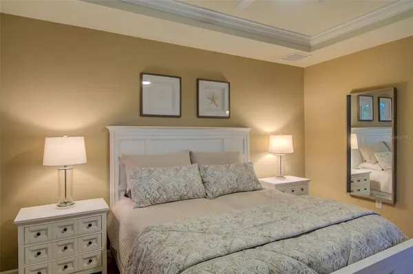 a bedroom with a bed and a night stand