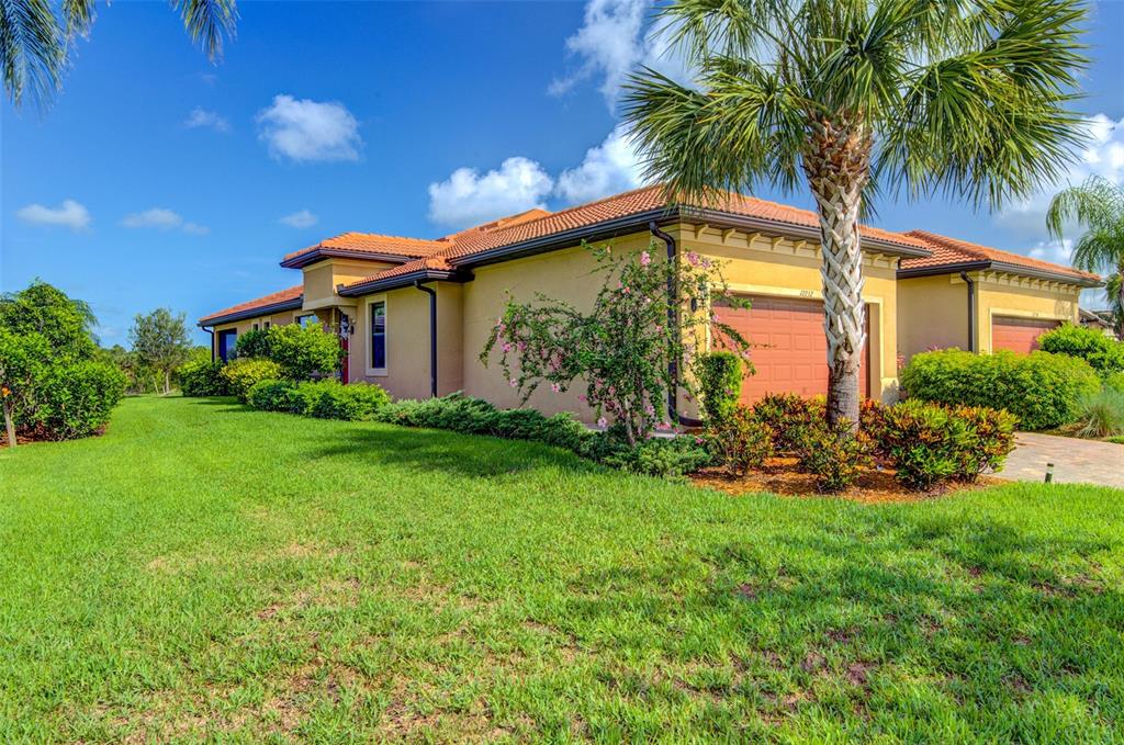 12232 Marsh Pointe Road Sarasota, FL 34238 - Photo 2 of 44 a front view of a house with garden
