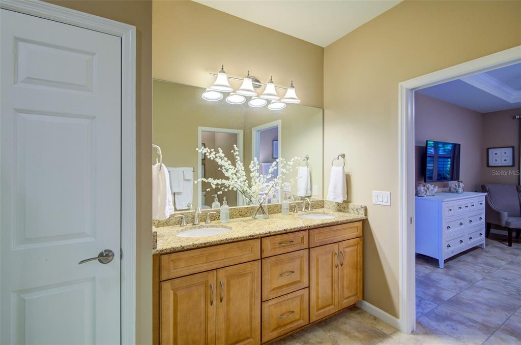 12232 Marsh Pointe Road Sarasota, FL 34238 - Photo 24 of 44 a bathroom with a double vanity sink and a mirror