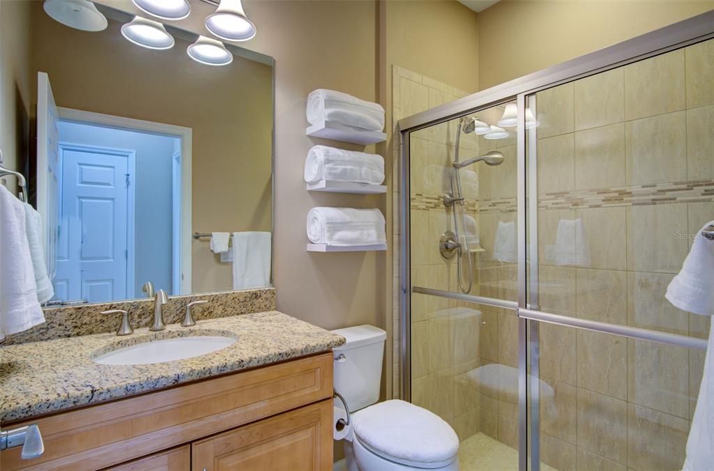 12232 Marsh Pointe Road Sarasota, FL 34238 - Photo 25 of 44 a bathroom with a granite countertop sink toilet and shower