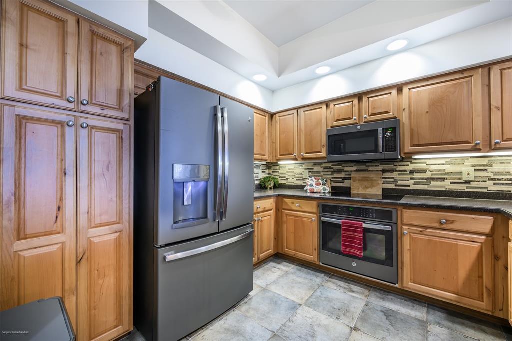 3313 Sunset Key Circle, Unit 104 Punta Gorda, FL 33955 - Photo 11 of 57 a kitchen with stainless steel appliances granite countertop a refrigerator stove microwave and sink