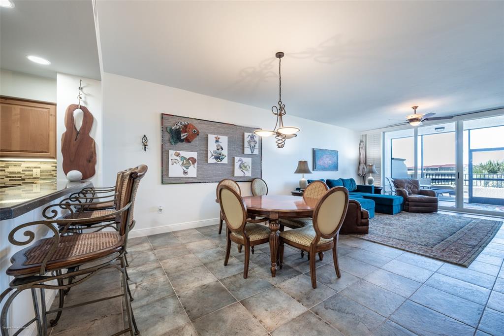3313 Sunset Key Circle, Unit 104 Punta Gorda, FL 33955 - Photo 16 of 57 a living room with furniture a large window and a dining table
