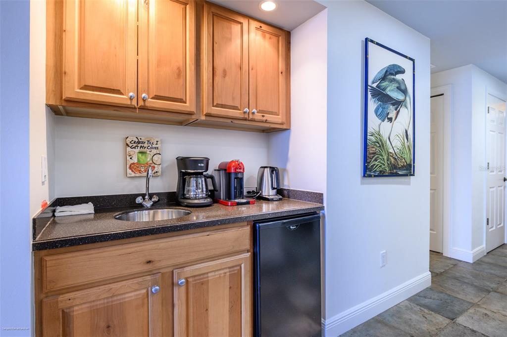 3313 Sunset Key Circle, Unit 104 Punta Gorda, FL 33955 - Photo 21 of 57 a kitchen with stainless steel appliances granite countertop a sink and cabinets with wooden floor