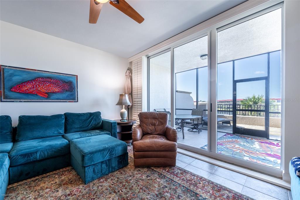 3313 Sunset Key Circle, Unit 104 Punta Gorda, FL 33955 - Photo 22 of 57 a living room with furniture and a floor to ceiling window