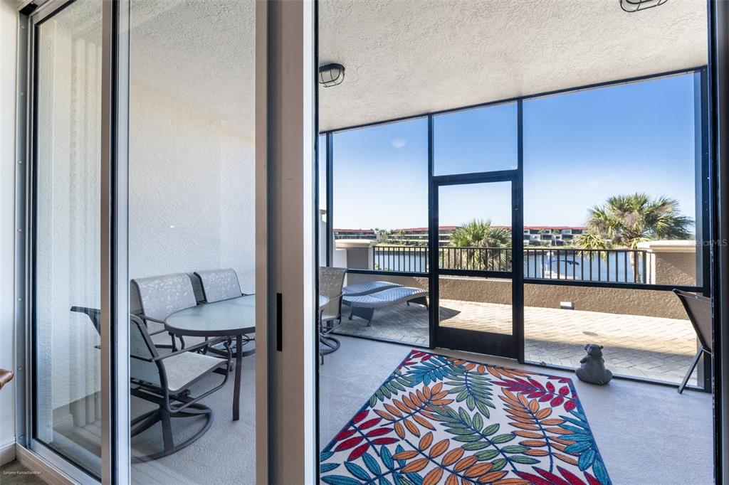 3313 Sunset Key Circle, Unit 104 Punta Gorda, FL 33955 - Photo 23 of 57 a bedroom with a bed and glass door