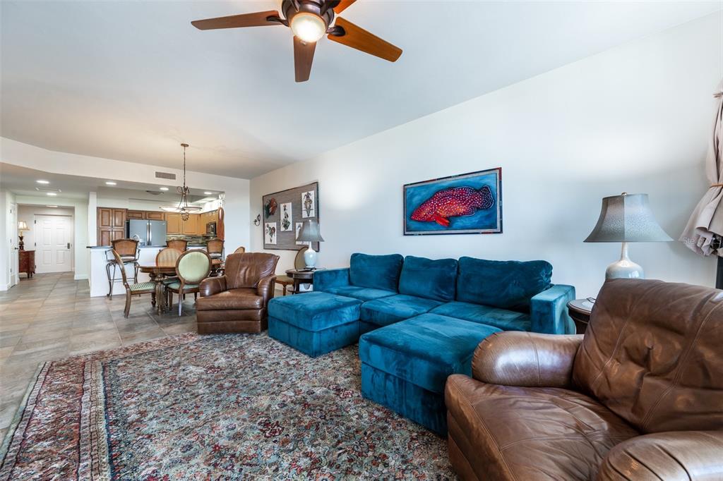 3313 Sunset Key Circle, Unit 104 Punta Gorda, FL 33955 - Photo 24 of 57 a living room with furniture and a chandelier