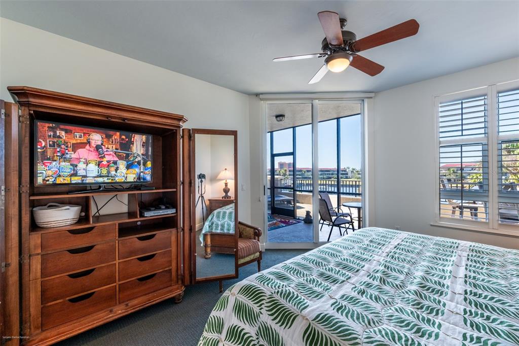 3313 Sunset Key Circle, Unit 104 Punta Gorda, FL 33955 - Photo 31 of 57 a bedroom with furniture and a flat screen tv