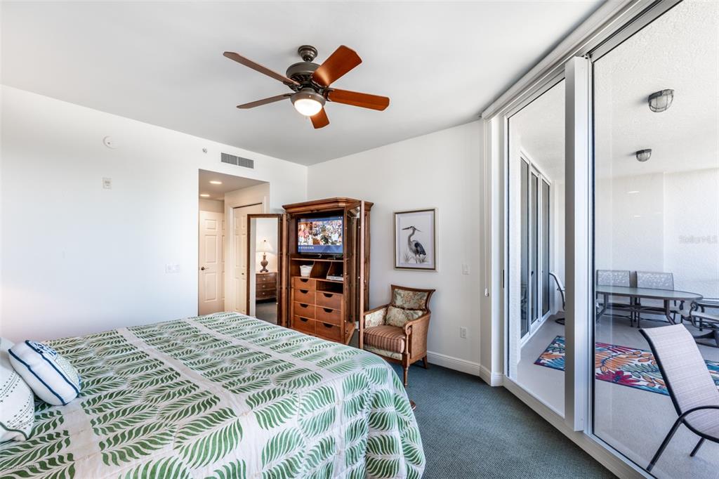 3313 Sunset Key Circle, Unit 104 Punta Gorda, FL 33955 - Photo 32 of 57 a bedroom with a large bed and a chandelier