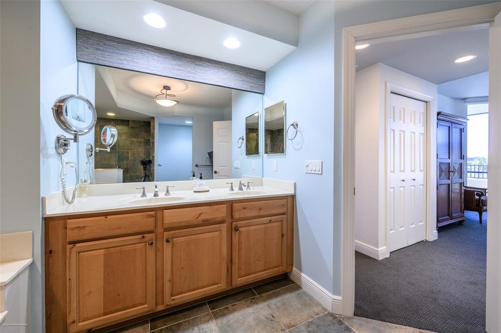 3313 Sunset Key Circle, Unit 104 Punta Gorda, FL 33955 - Photo 36 of 57 a bathroom with a double vanity sink and a mirror