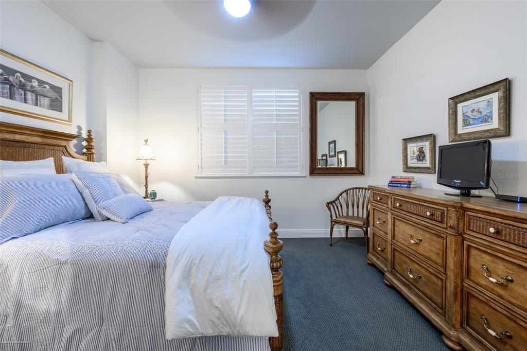 3313 Sunset Key Circle, Unit 104 Punta Gorda, FL 33955 - Photo 40 of 57 a bedroom with a bed and a flat screen tv