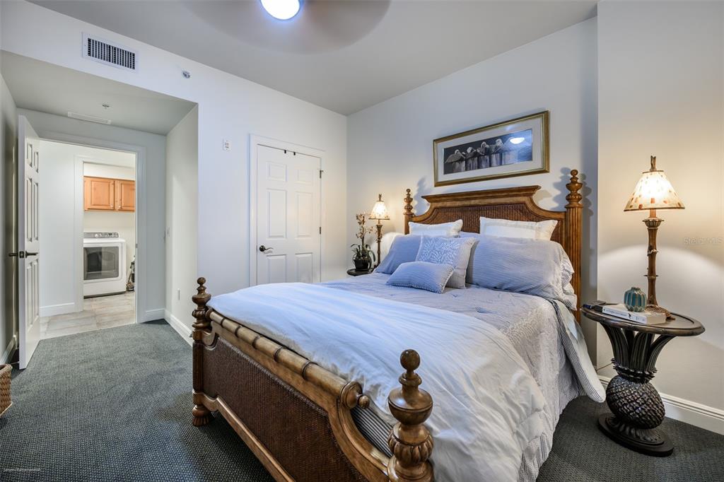 3313 Sunset Key Circle, Unit 104 Punta Gorda, FL 33955 - Photo 41 of 57 a bedroom with a bed and a chandelier