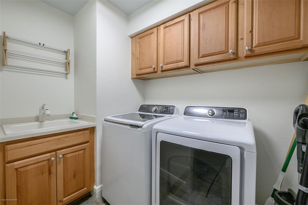 3313 Sunset Key Circle, Unit 104 Punta Gorda, FL 33955 - Photo 43 of 57 a utility room with sink dryer and washer